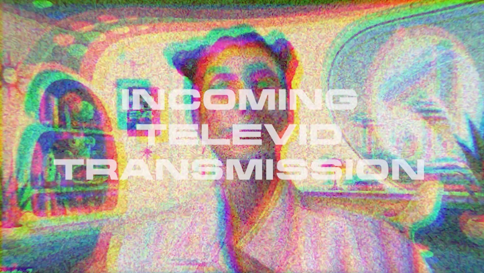 Glitchy, rainbow-distorted video still reading “Incoming Televid Transmission” from the Yellow Team’s Kiki Assists presentation from the future.
