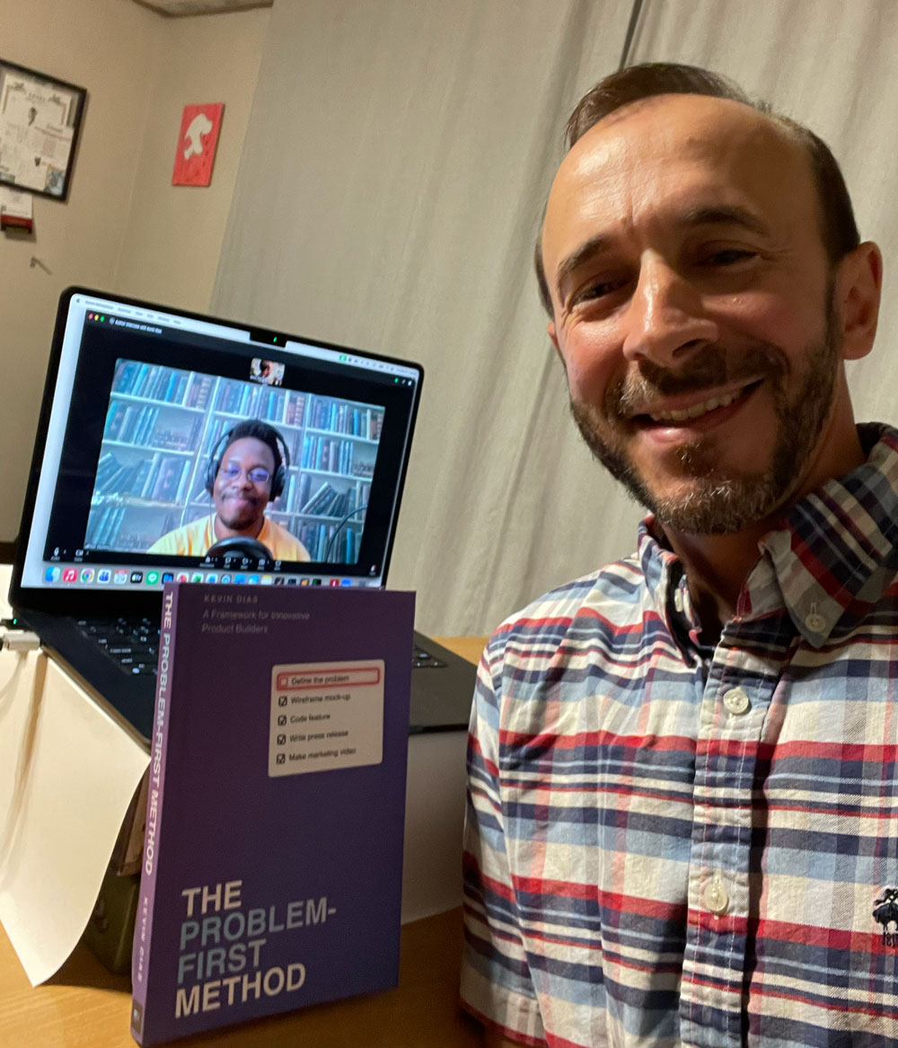 Kevin Dias holding The Problem-First Method with Peter Okonkwo on screen during the P. English Literature interview