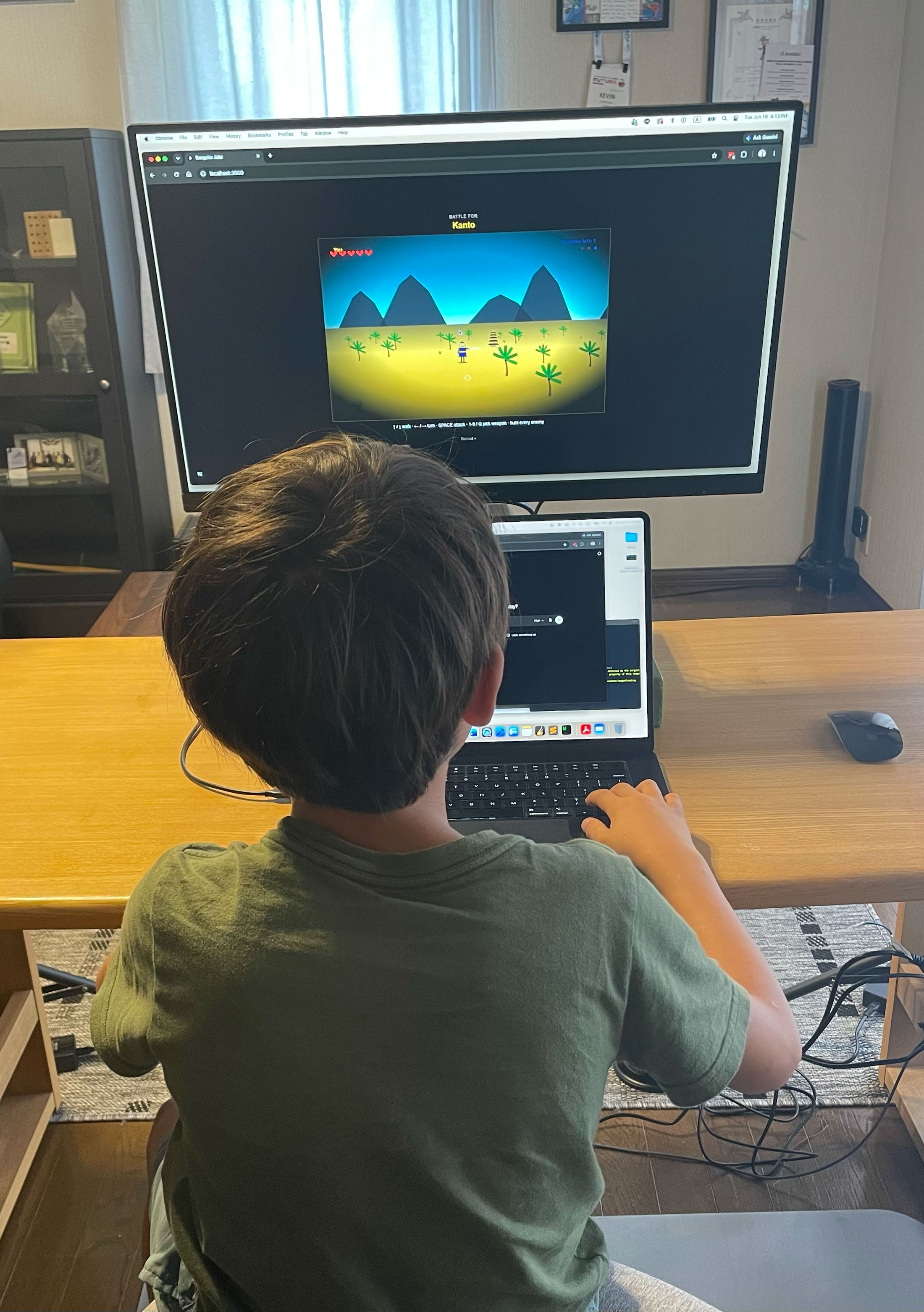 My son building his samurai game at the computer